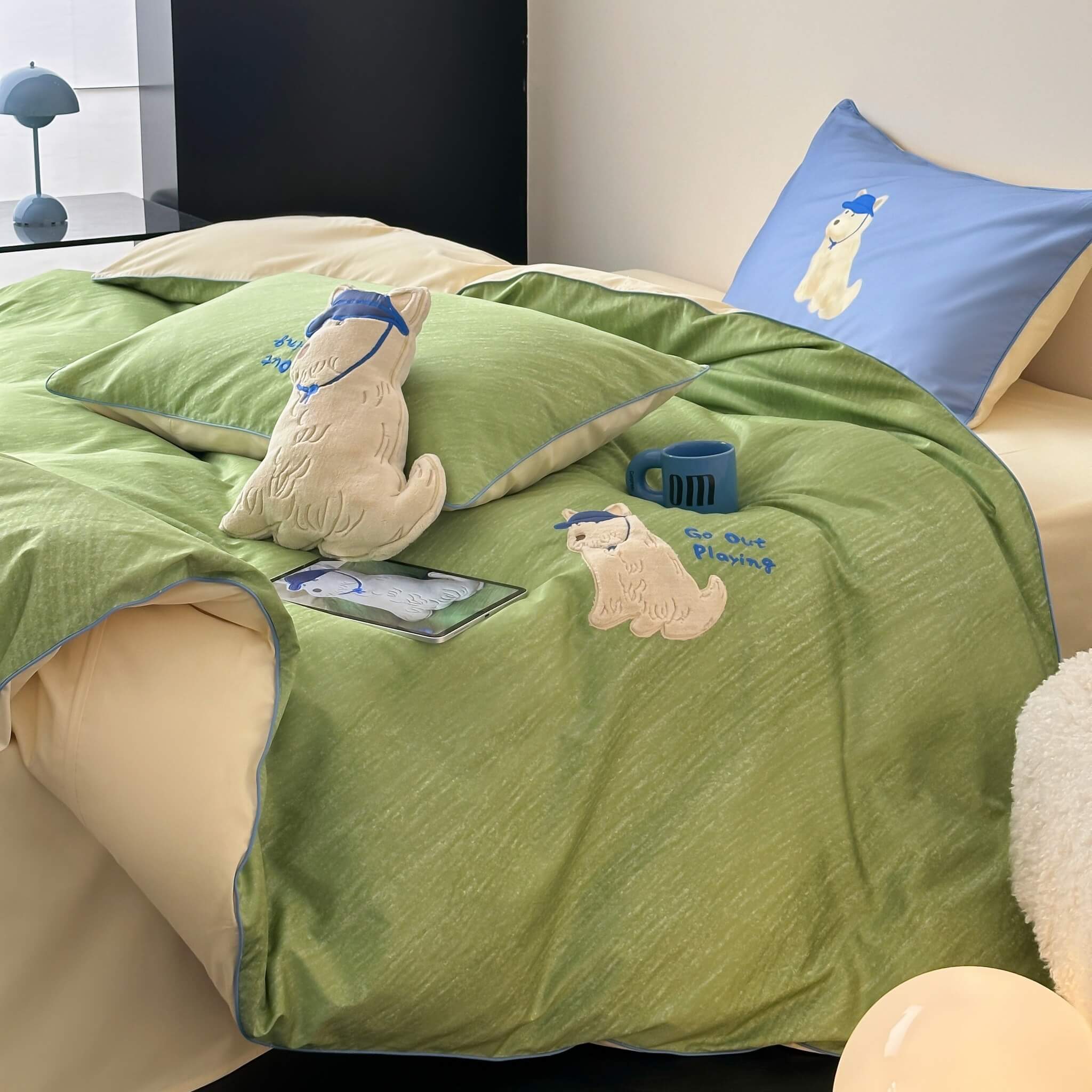 Green  cotton bedding set with cartoon dog characters on a bed in a room.