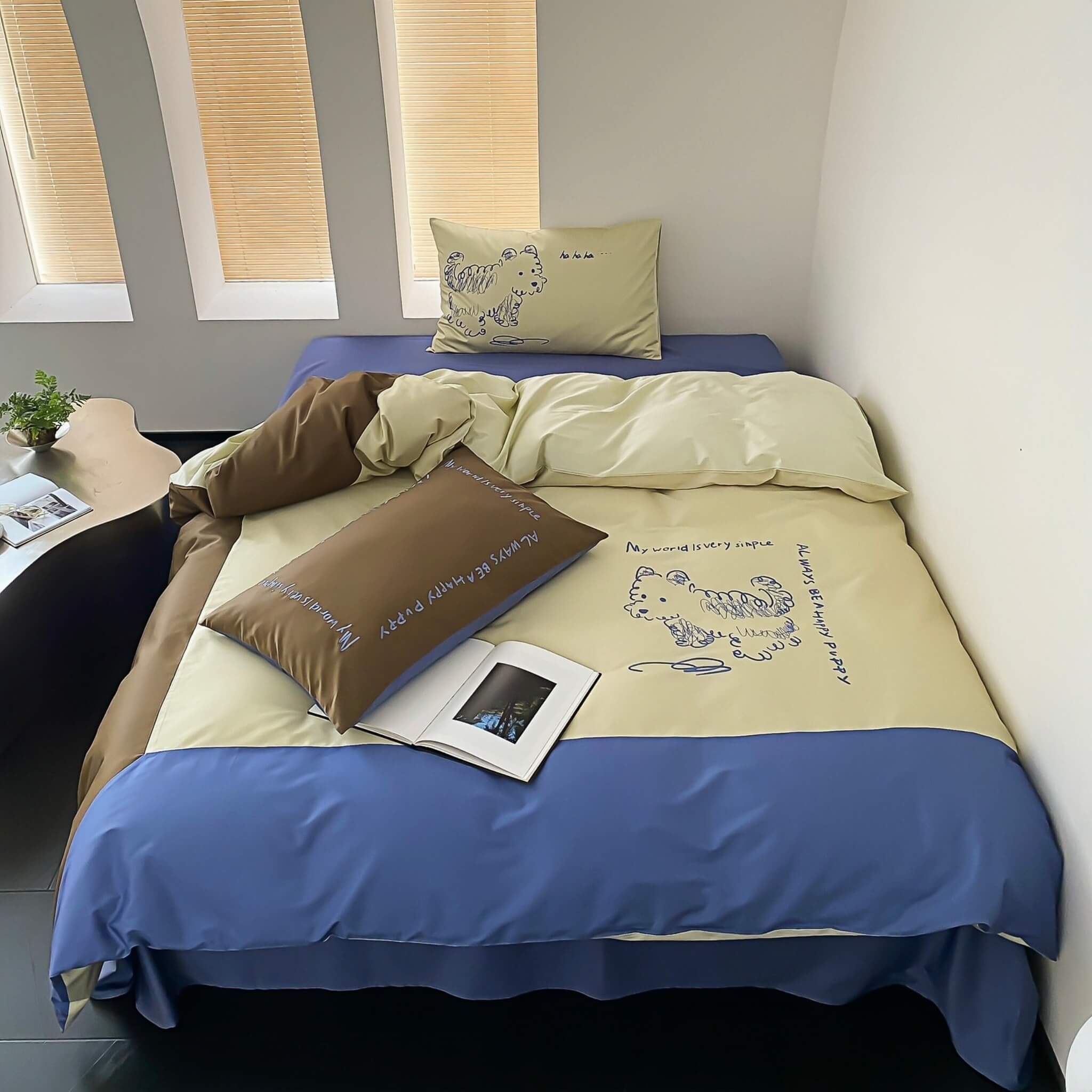 Beddings with a mix color of beige, green and brrown and embroided dog design in a room setting.