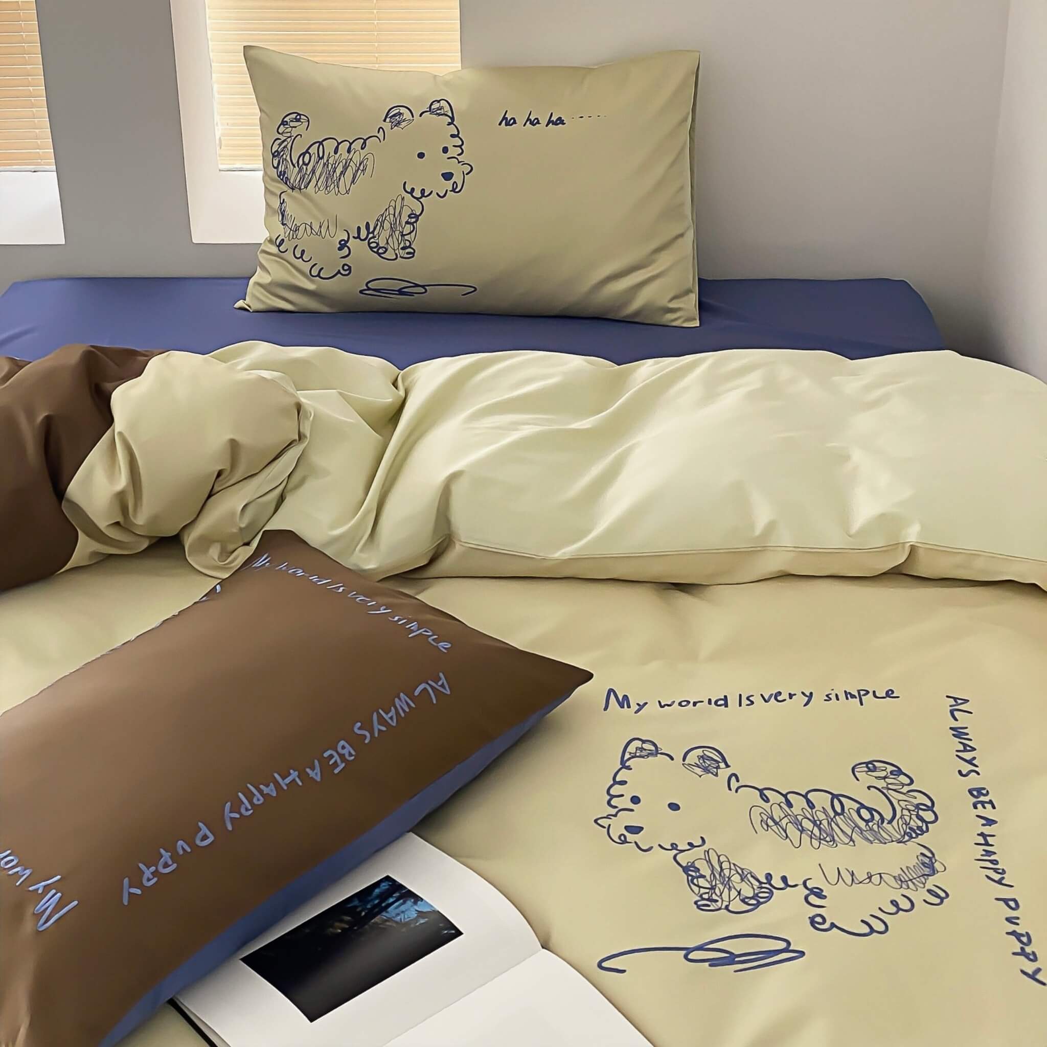 Bed with beige bedding and brown pillows featuring dog illustrations and text.