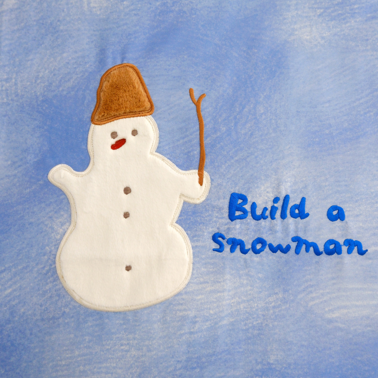 Cartoon snowman with a brown hat and red nose on a blue background with 'Build a Snowman' text.