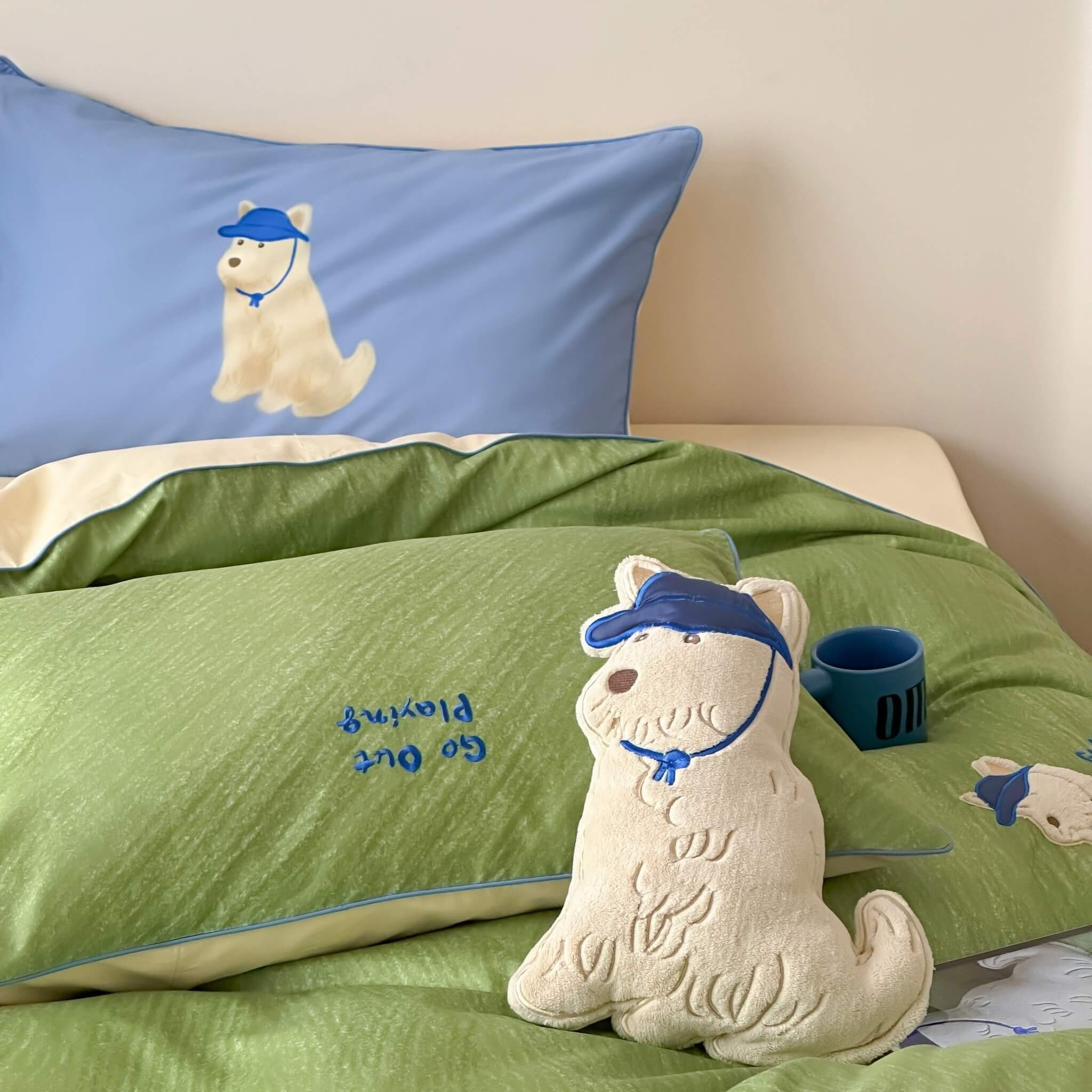 bedroom with green bedding and blue pillow featuring a cartoon dog.